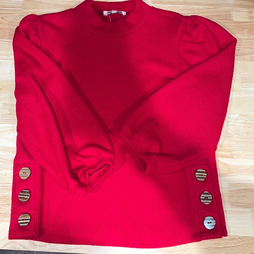 Red high neck 3/4 sleeve shirt. Detailed with buttons up the side